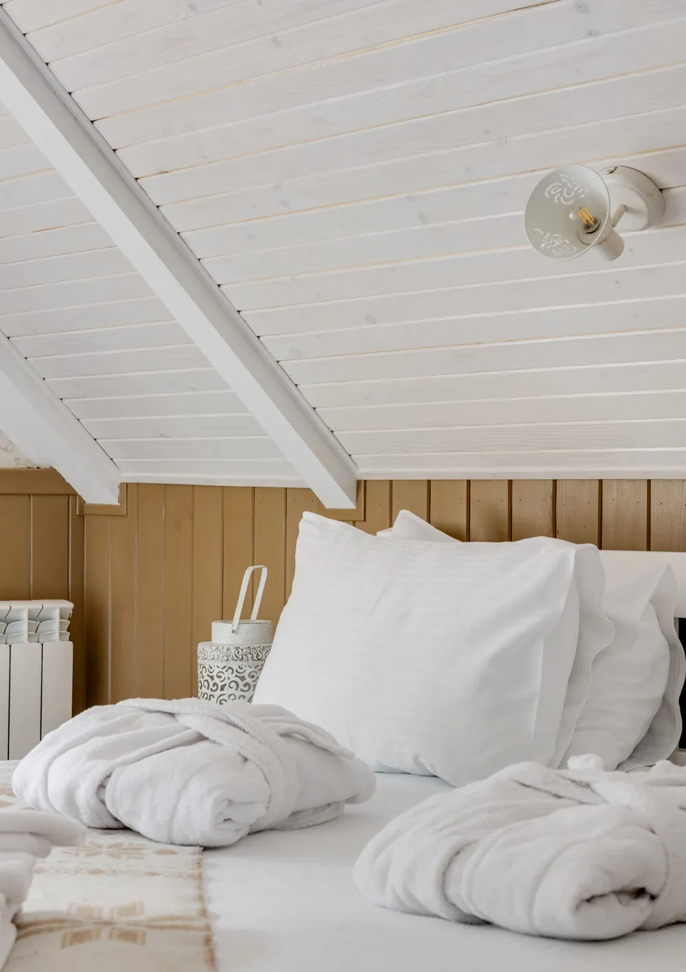 Bright bedroom with light bedding set up for sleeping with hot flashes