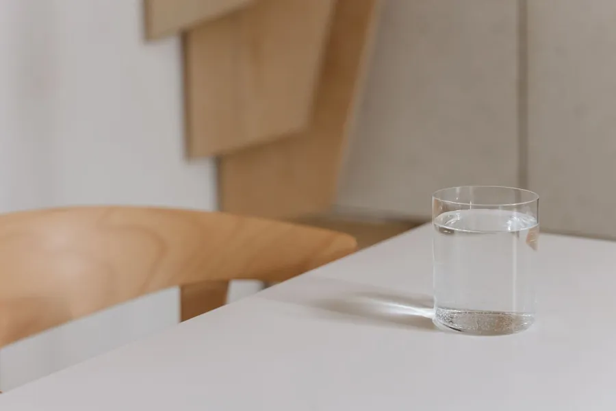 Glass of water on a table, part of falling back asleep after a hot flash