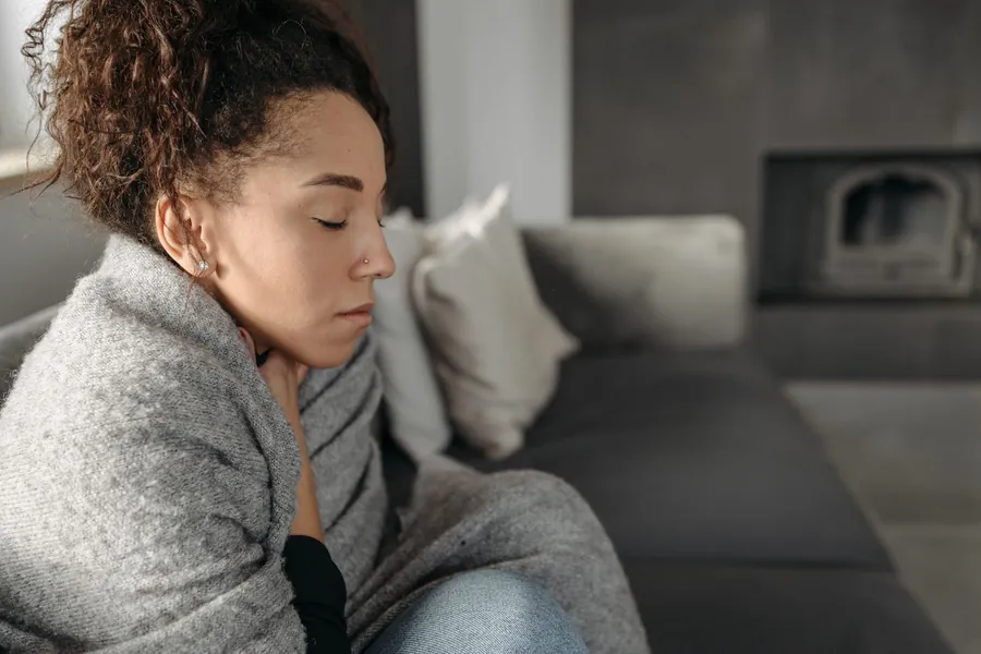 Tired woman on a sofa after a night of hot and cold flashes