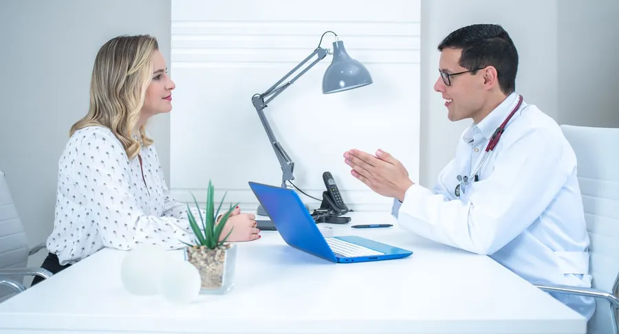 Woman talking with her doctor about hot flash treatment